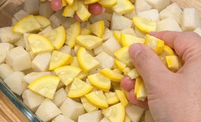 Scatter sliced raw yellow squash over raw cubed white potatoes, together with 2 ingredients, into a glass casserole dish for a rustic summer supper th