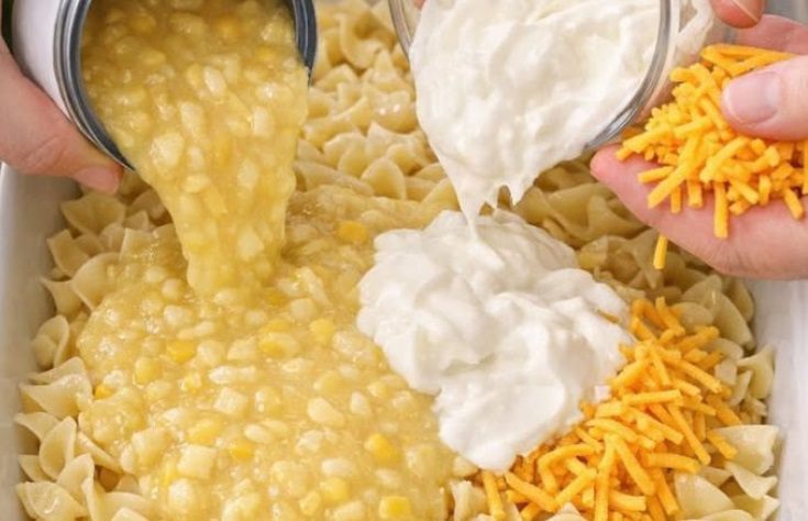 Pour cream style corn and these 2 ingredients over uncooked egg noodles into a casserole dish for a hearty dinner that families request weekly.